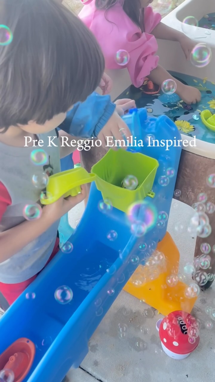 Discovery Pre-K4 students exploring water, motion, and bubbles outside