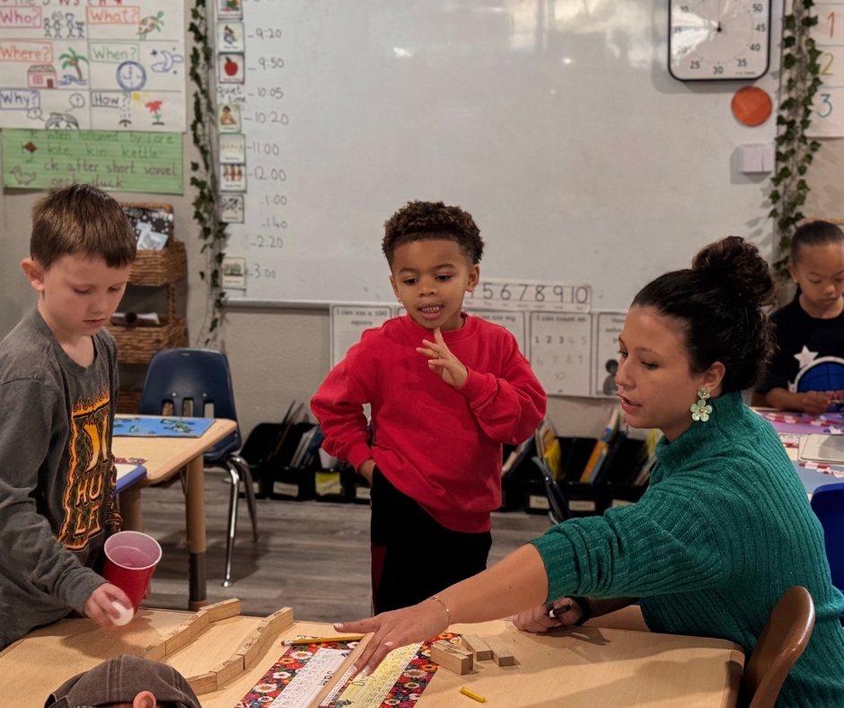 Teacher guiding students through a hands-on classroom activity